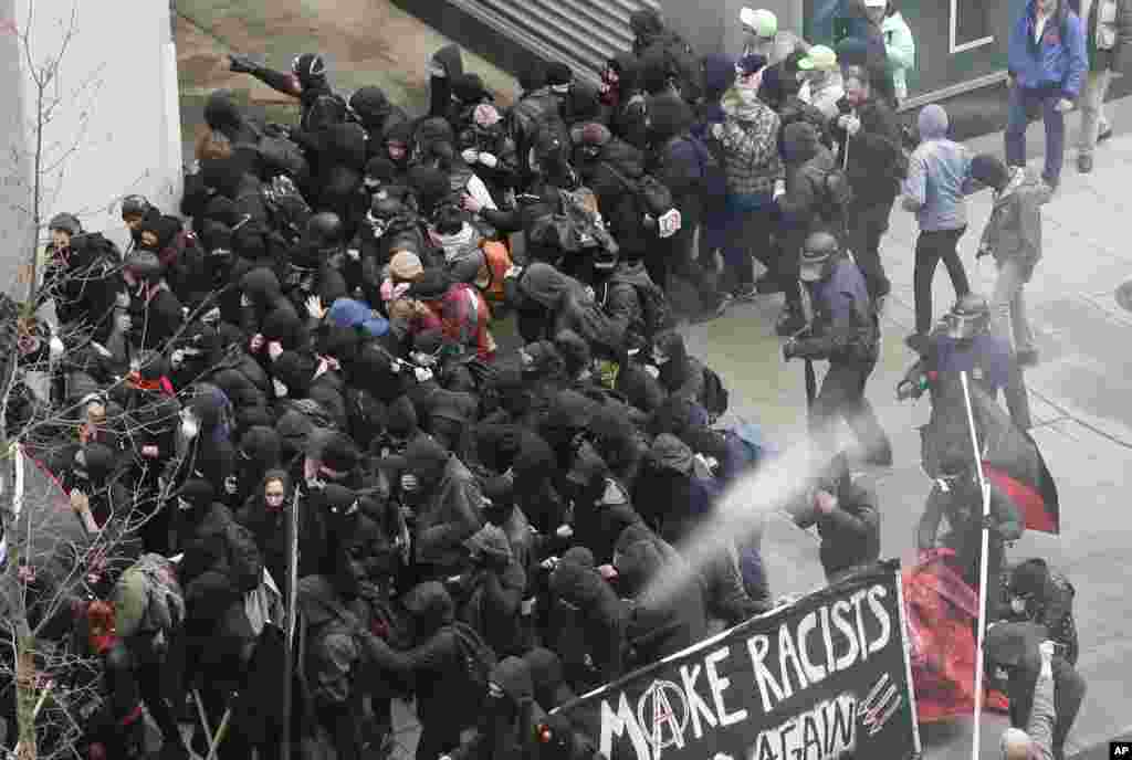 Police use pepper spray on protesters in Washington, Friday, Jan. 20, 2017, in a chaotic confrontation blocks from Donald Trump&#39;s inauguration as protesters registered their rage against the new president.