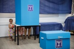 A woman votes at a polling station in Rosh Haayin, Israel, Sept. 17, 2019.