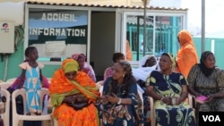 FILE - Women wait outside the Philippe Maguilen Senghor health center for free breast and cervical cancer screenings in Dakar, Senegal, on April 22, 2017.