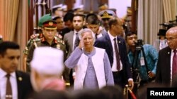 FILE PHOTO: Nobel laureate Muhammad Yunus salutes to the attendees upon arrival at the Bangabhaban to take oath as the head of the interim government