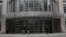 FILE - People stand outside a federal courthouse in New York City. 