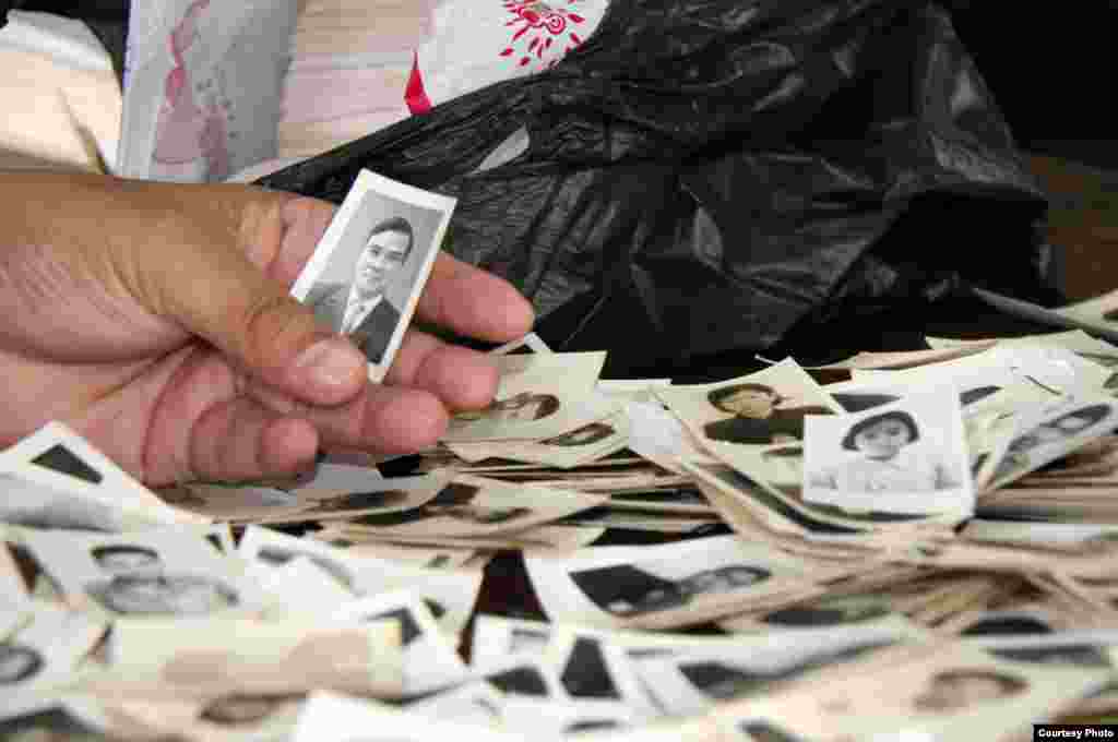 A staff member sorts through photographs recently donated to the center. (Credit: DC-Cam)