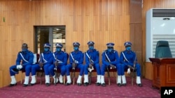 Burkina Faso Police guard the courtroom where 14 people, including former President Blaise Compaore, stand trial as charged with the murder of leader Thomas Sankara, in Ougadougou, Burkina Faso, Oct. 11, 2021