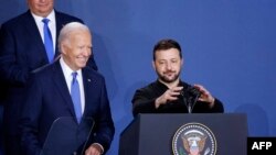 Ukraine's President Volodymyr Zelensky speaks alongside US President Joe Biden during a Ukraine Compact initiative on the sidelines of the NATO Summit at the Walter E. Washington Convention Center in Washington, DC, on July 11, 2024. (Photo by Ludovic MAR