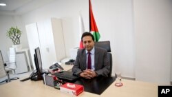 FILE - Palestinian cell phone provider Wataniya CEO Durgham Maraee speaks during an interview with the Associated Press at his office in the West Bank city of Ramallah, Jan. 10, 2018.