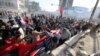 Protesters calling for government reforms run from tear gas fired by Iraqi security forces to disperse the crowd in central Baghdad, Iraq, May 27, 2016.