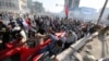 Protesters calling for government reforms run from tear gas fired by Iraqi security forces to disperse the crowd in central Baghdad, Iraq, May 27, 2016.