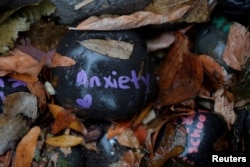 FILE - A stone with the word "Anxiety" forms part of the "COVID-19 Cairn," at Tufts Medical Center in Boston. (REUTERS/Brian Snyder/File Photo)