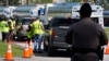 A Florida Highway Patrol officer watches as fuel depot workers distribute gas to residents Oct. 12, 2024, in Plant City, Fla.