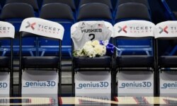 A seat with a jersey and flowers is reserved in memory of Gianna Bryant before an exhibition basketball game in the first half of a basketball game against the US, Monday, Jan. 27, 2020, in Hartford, Conn.