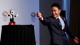 Japanese fencing Olympian Yuki Ota participates in a demonstration with talking robot Mirata during a news conference in support of the Tokyo 2020 summer Olympics candidacy in Buenos Aires, Argentina. The International Olympic Committee (IOC) will elect the host city for the 2020 summer Olympics at their session Sept. 7.