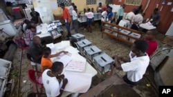 FILE - Election workers at a voting station set up in a government office building in Port-au-Prince, Haiti.