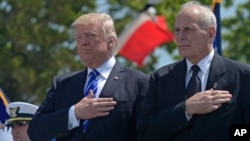 President Donald Trump and Homeland Security Secretary John Kelly, right, listen to the national anthem during commencement exercises at the U.S. Coast Guard Academy in New London, Connecticut, May 17, 2017.