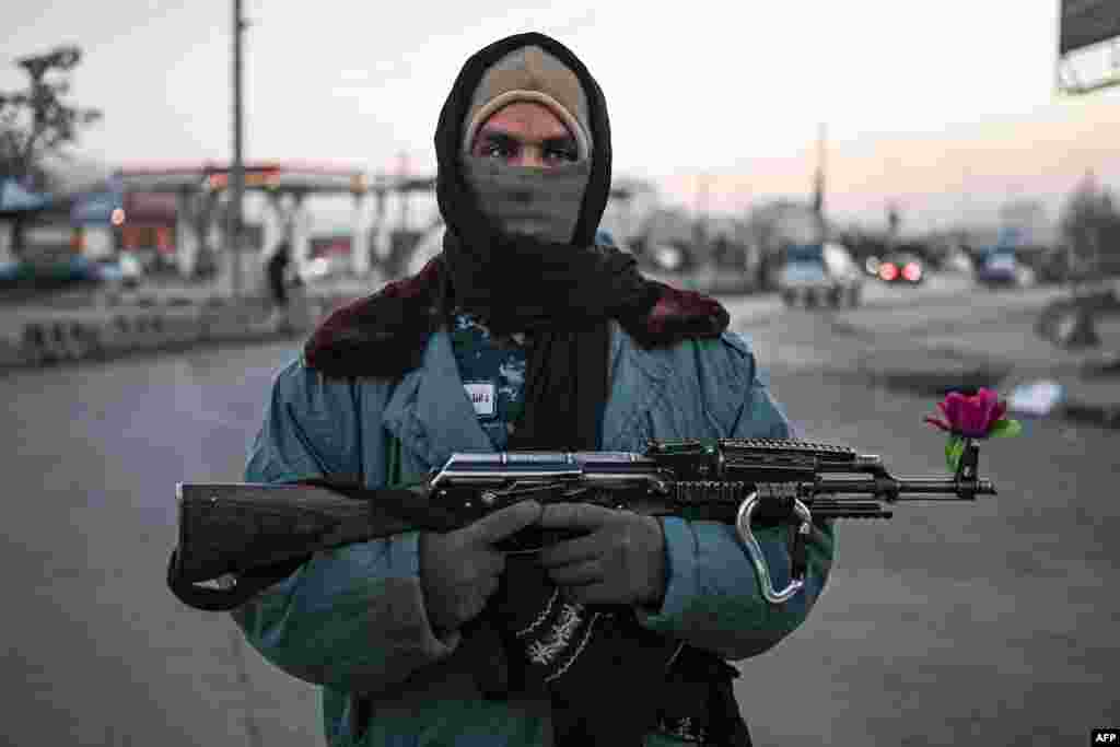 A Taliban fighter stands guard at a checkpoint on a street in Kabul, Afghanistan.&nbsp;