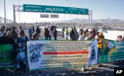 FILE - People belonging to farmers' associations block the El Paso to Ciudad Juarez bridge, on the Mexican side, during a protest against the 20th anniversary of the North American Free Trade Agreement (NAFTA) in Ciudad Juarez, Mexico, Jan. 2, 2014.
