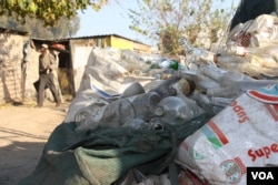Piles of empty liquor bottles are everywhere in the streets of Diepsloot. (D. Taylor/VOA)