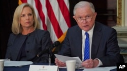 Homeland Security Secretary Kirstjen Nielsen, left, listens as Attorney General Jeff Sessions, right, speaks during a meeting in Washington, Aug. 16, 2018.