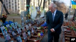 U.S. Vice President Joe Biden pays his respects at a memorial honoring dozens of demonstrators killed during 2013-1014 anti-government protests in Kyiv, in Ukraine's capital, Dec. 7, 2015.