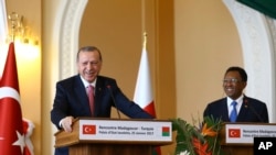 FILE - Turkey's President Recep Tayyip Erdogan, left, and Madagascar President Hery Rajaonarimampianina speak to the media during a joint news conference in Antananarivo, Madagascar, Wednesday, Jan. 25, 2017.