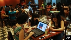Three young Vietnamese girls go online at a cafe in Hanoi, Vietnam, May 14, 2013. The country’s potential for growth, young population and good Internet infrastructure have made it an attractive destination for regional and international investors and startups.