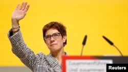 Annegret Kramp-Karrenbauer waves after being elected as the party leader during the Christian Democratic Union (CDU) party congress in Hamburg, Germany, Dec. 7, 2018. 