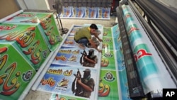 A Palestinian prints posters in preparation for a prisoner swap between Hamas and Israel, in Gaza City, October 16, 2011.