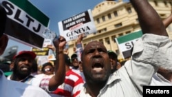 A group of Sri Lankan Muslims shout slogans, protesting against the UN and U.S resolution against Sri Lankan war crimes, during a demonstration as they march towards U.S embassy in Colombo, March 26, 2014. 