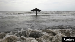 FILE - Waves are seen crashing ashore at Mayangan village in Subang in Indonesia's West Java province.
