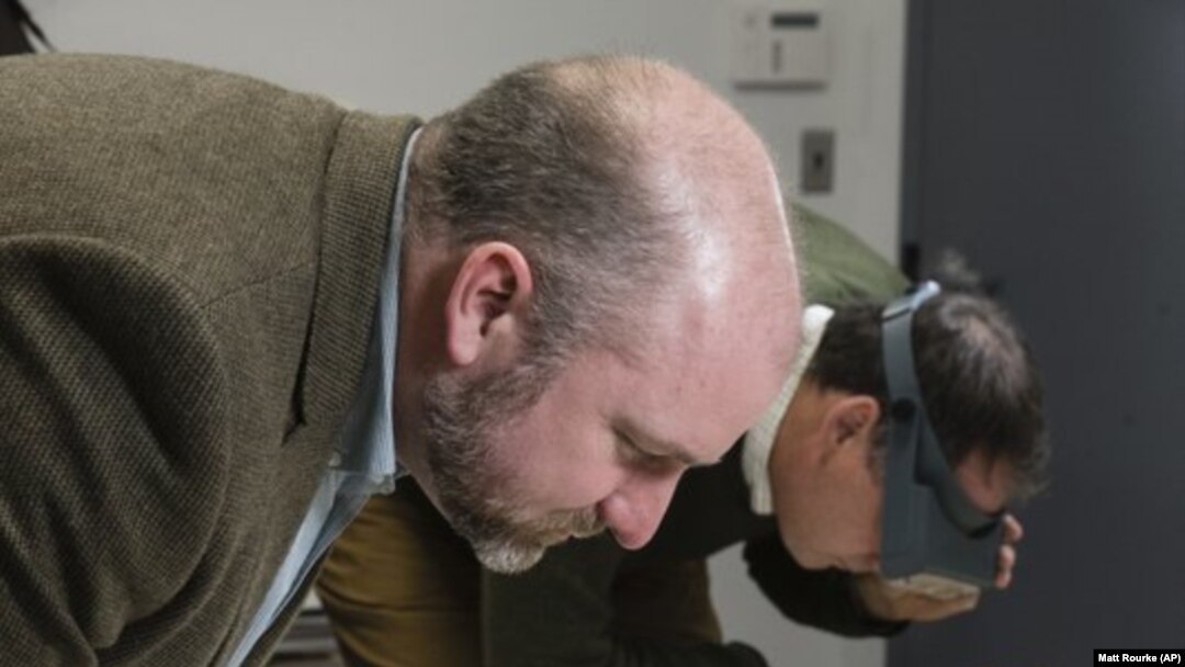 Phillip Mead (left) and Scott Stephenson view a newly discovered painting that shows George Washington's army tent during the Revolutionary War.