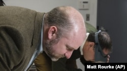 Phillip Mead (left) and Scott Stephenson view a newly discovered painting that shows George Washington's army tent during the Revolutionary War.