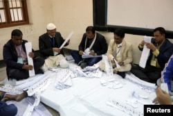 Election officers count votes at a voting center after polling ended in Dhaka, Bangladesh, Dec. 30, 2018.