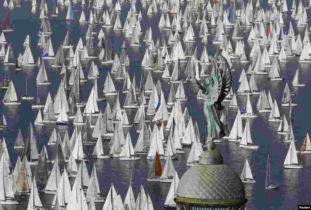 Sailing boats gather at the start of the Barcolana regatta in front of Trieste harbor. The annual Barcolana regatta in the Gulf of Trieste near northern Italy is one of the largest sailing races in the world with over 1,800 participants. 