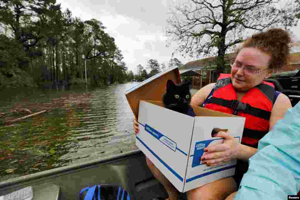 Carla Ramm checks on her cat Jackjack after they were loaded onto a boat during their rescue from rising flood waters in the aftermath of Hurricane Florence, in Leland, North Carolina.