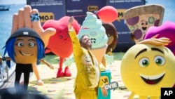 FILE - Actor T. J. Miller poses with characters for the film "The Emoji Movie," at the 70th international film festival, Cannes, May 16, 2017. 