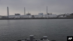Tokyo Electric Power Co.'s Fukushima Daiichi Nuclear Power Plant is seen from a Japan Maritime Self-Defense Force vessel off Fukushima Prefecture, northeastern Japan, in this photo taken on March 31 and released by Japan Defense Ministry April 1, 2011