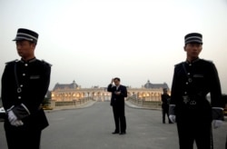 FILE - Chinese security personnel stand guard at a mansion on the edge of Beijing, Sept. 29, 2010.
