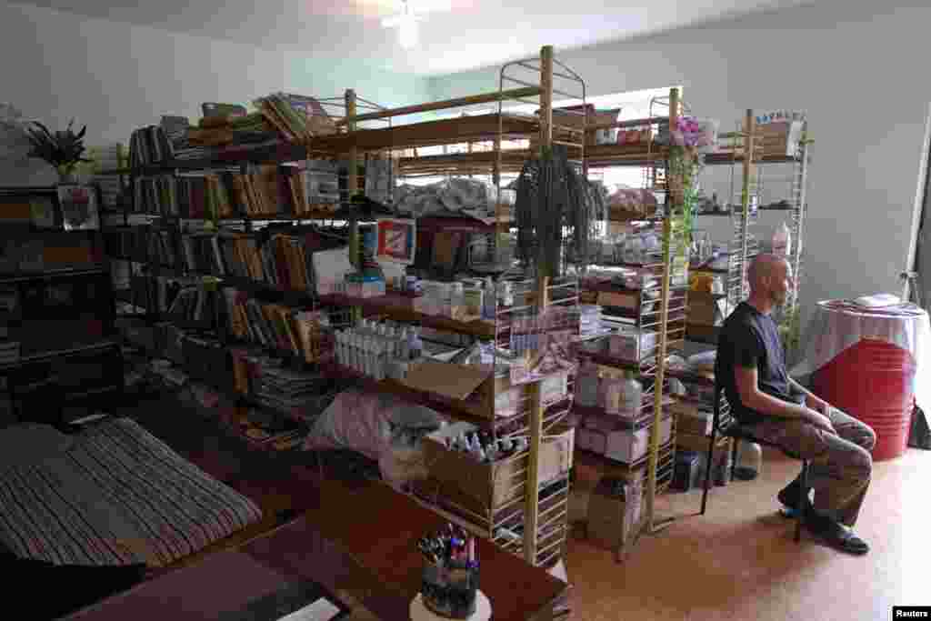 A member of the Ukrainian military self-defense battalion "Donbas" sits in a school library, currently used as a medical post, in the eastern town of Popasna in the Donetsk region, Aug. 18, 2014.