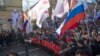 Demonstrators carry portraits of slain opposition leader Boris Nemtsov and a big poster reading "Killed for Freedom" during a march marking the one-year anniversary of his killing, in Moscow, Russia, Feb. 27, 2016.