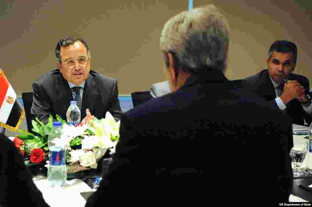 Egyptian Foreign Minister Nabil Fahmy speaks with U.S. Secretary of State John Kerry at the outset of a meeting in Cairo, Egypt, on November 3, 2013.