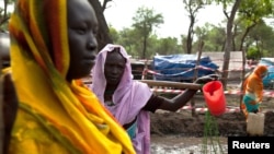 Women gather to collect water at the Yusuf Batil refugee camp in Upper Nile, South Sudan, July 4, 2012.