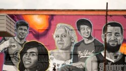 A man walks past the commissioned mural titled We are Rockford, by Artist, Ryan "Stuk One" Lape of famous Rockford, Ill., natives Sept. 20, 2021, in Rockford.