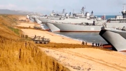 FILE - This frame from a video released on April 23, 2021, by the Russian Defense Ministry Press Service shows Russian troops boarding landing vessels after drills in Crimea. Ukrainian and Western officials are worried that a Russian military buildup near Ukraine could signal plans by Moscow to invade its ex-Soviet neighbor.