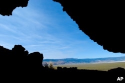 File--This July 23, 2008, photo was taken from inside the Paisley Caves near Paisley, Ore., where archaeologists found stone tools and human DNA dating back more than 13,000 years, evidence humans settled North America earlier than previously thought.