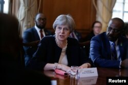 FILE - Britain's Prime Minister Theresa May hosts a meeting with leaders and representatives of Caribbean countries, at 10 Downing Street in London, April 17, 2018.