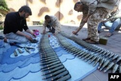 Fighters from a Misrata armed group loyal to the internationally recognized Libyan Government of National Accord (GNA) prepare their ammunition before heading to the front line as battles against Forces of Libyan strongman Khalifa Haftar continue on the outskirts of the capital Tripoli, April 9, 2019.