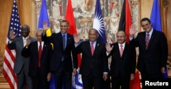 U.S. President Barack Obama poses for a family photo with leaders of island nations under threat by rising sea levels during the World Climate Change Conference 2015 (COP21) in Paris, Dec. 1, 2015.