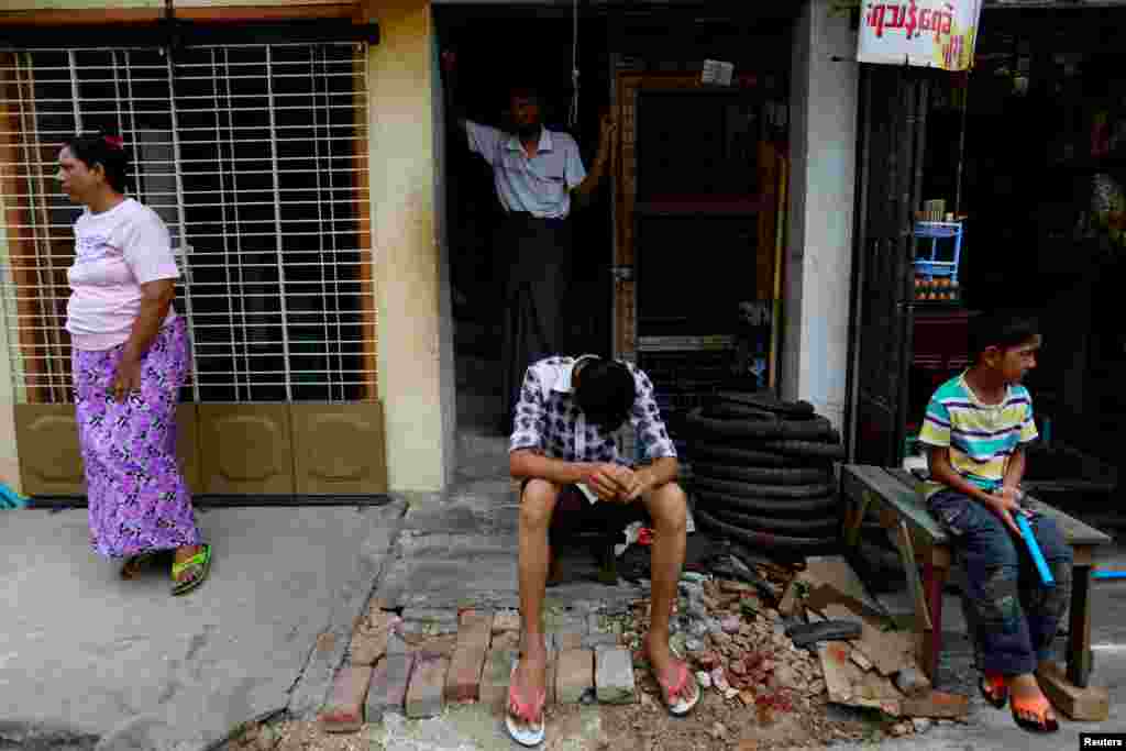 Muslims are pictured in front of their home in Mandalay, Myanmar, July 3, 2014.