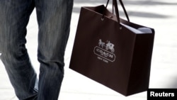 FILE - A shopping bag from the luxury brand Coach is seen along Rodeo Drive in Beverly Hills, California, May 21, 2013. 