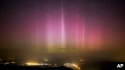 FILE - The Northern Lights (Aurora borealis) are seen on the sky above Pilisszentkereszt, north of Budapest, Hungary, on March 18, 2015. Parts of Britain and Germany have been treated to a display of the northern lights, a colorful phenomenon that is usually only seen further north.