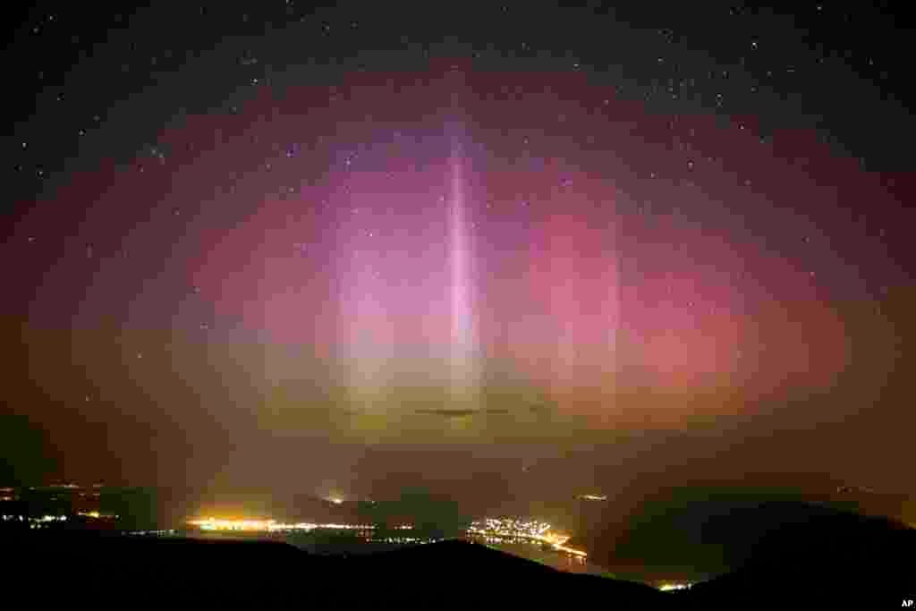 The Northern Lights (Aurora borealis) are seen on the sky above Pilisszentkereszt, 26 kms north of Budapest, Hungary, Wednesday morning, March 18, 2015. Photo was taken from the viewpoint of Dobogoko in Salgotarjan. (AP Photo/MTI,Balazs Mohai)